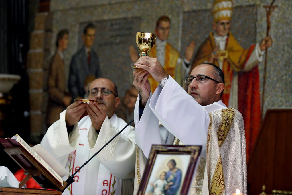 Christian priests conduct a mass at the Latin Patriarchate Church in